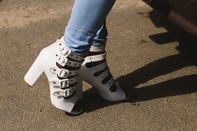 person showing pair of white peep toe chunky heel sandals