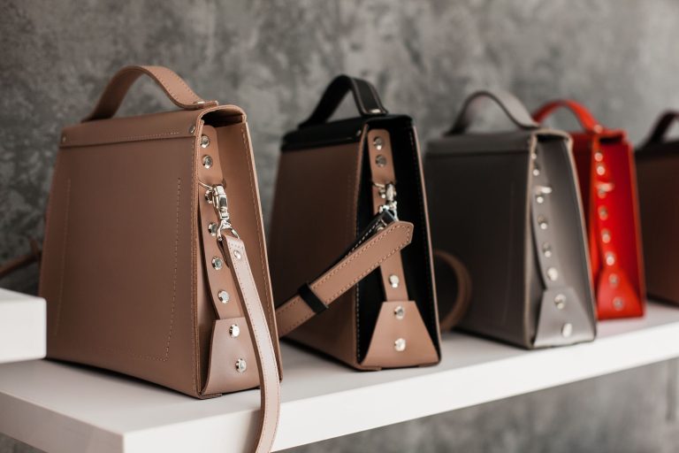 leather bags on white wooden shelf